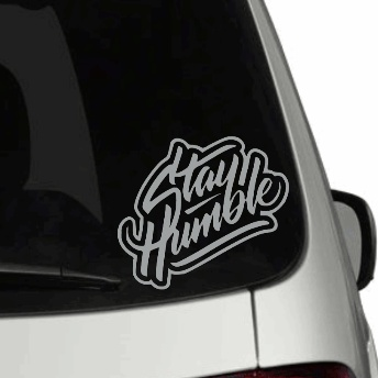Personalized "Stay Humble" car decal on a rear window of a vehicle.