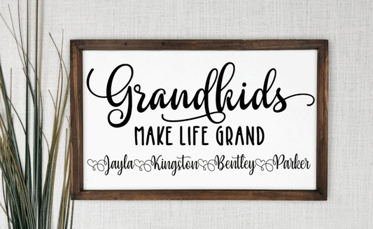Personalized handcrafted sign with "Grandkids Make Life Grand" text, custom names, antique white background, and stained pine frame.