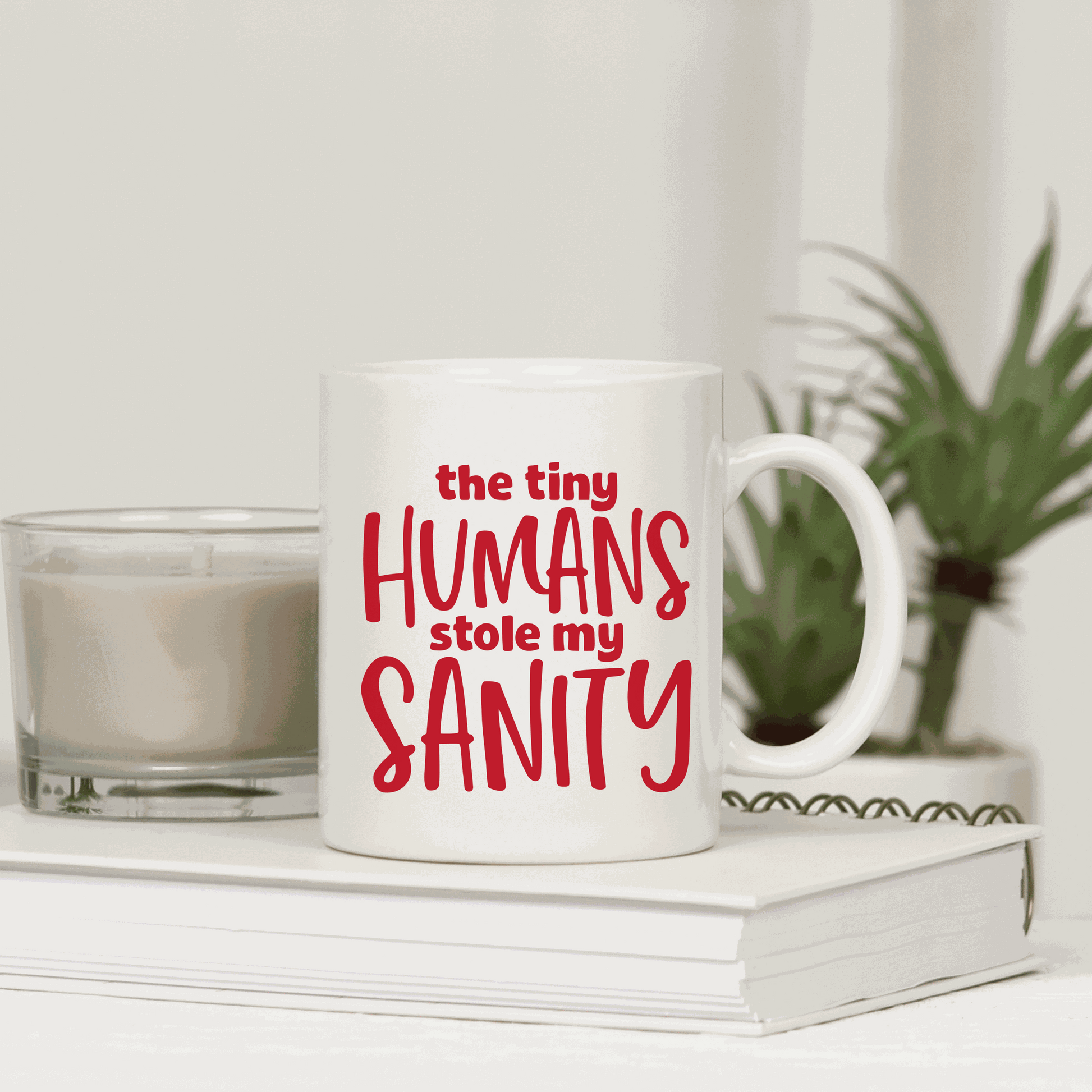 Funny ceramic mug with "The Tiny Humans Stole My Sanity" text, ideal for new parents, customizable colors.