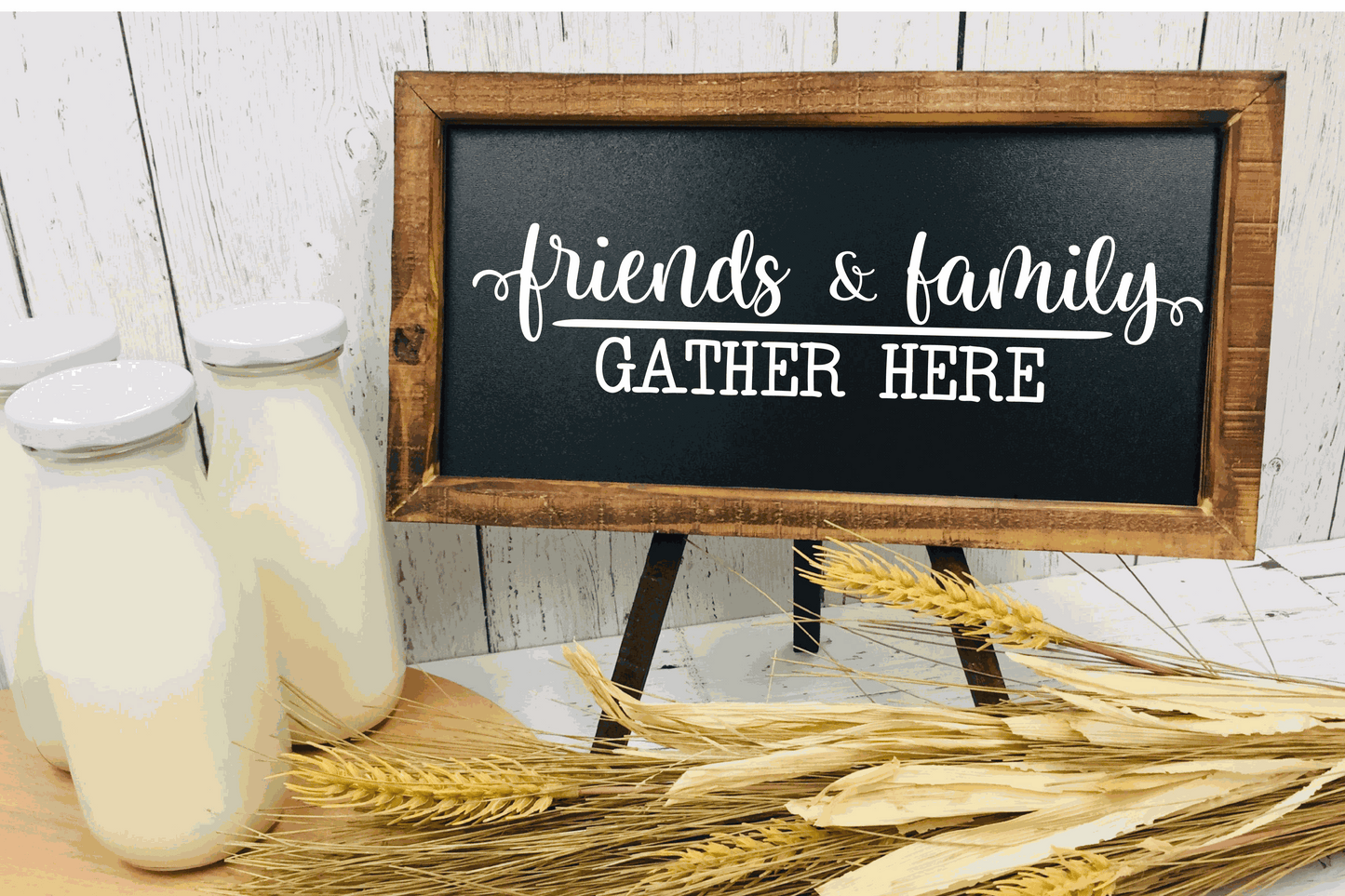 Handcrafted wood sign reading "Friends and Family Gather Here" with rustic frame, displayed on black background.