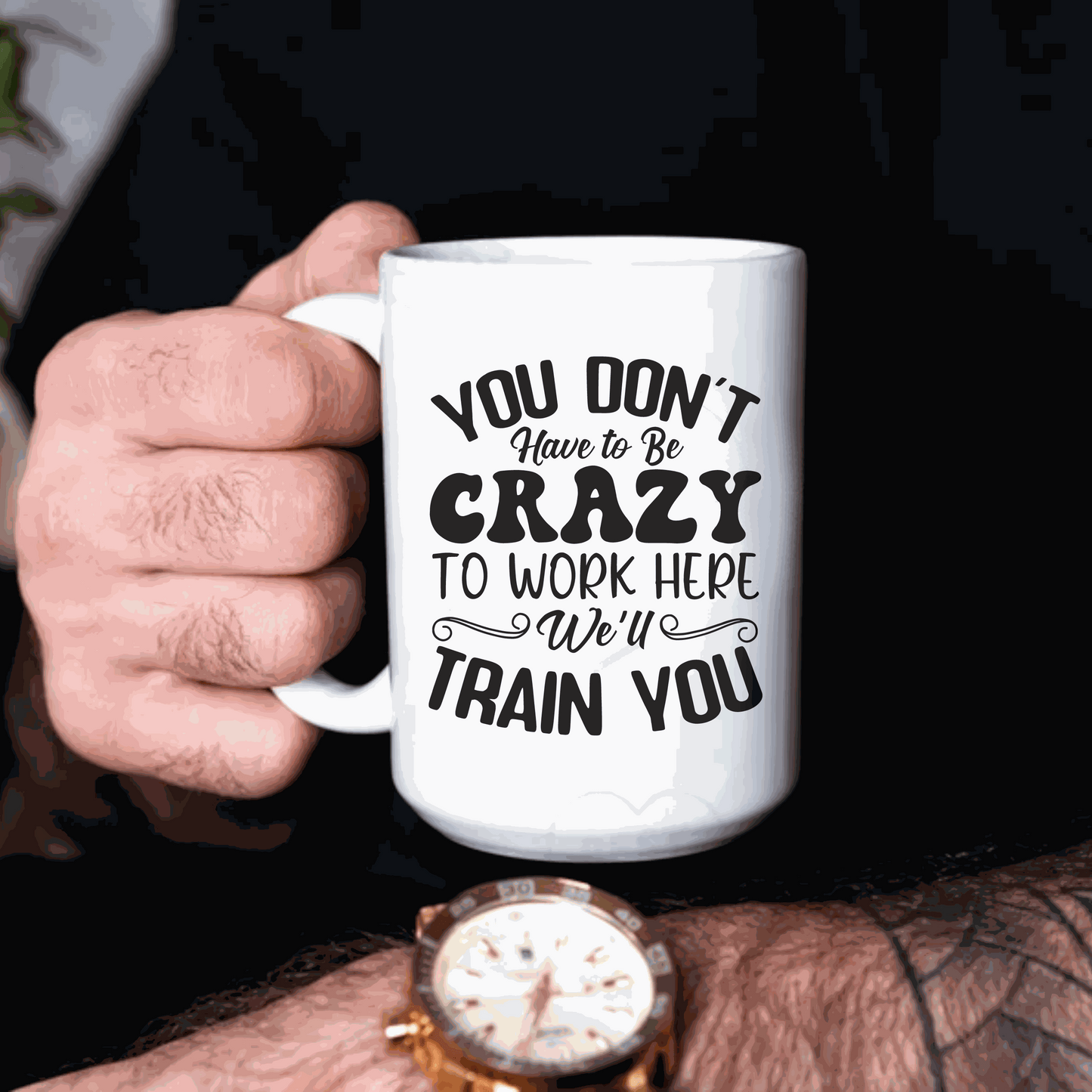 Ceramic mug with "You Don't Have to Be Crazy to Work Here, We'll Train You" design.