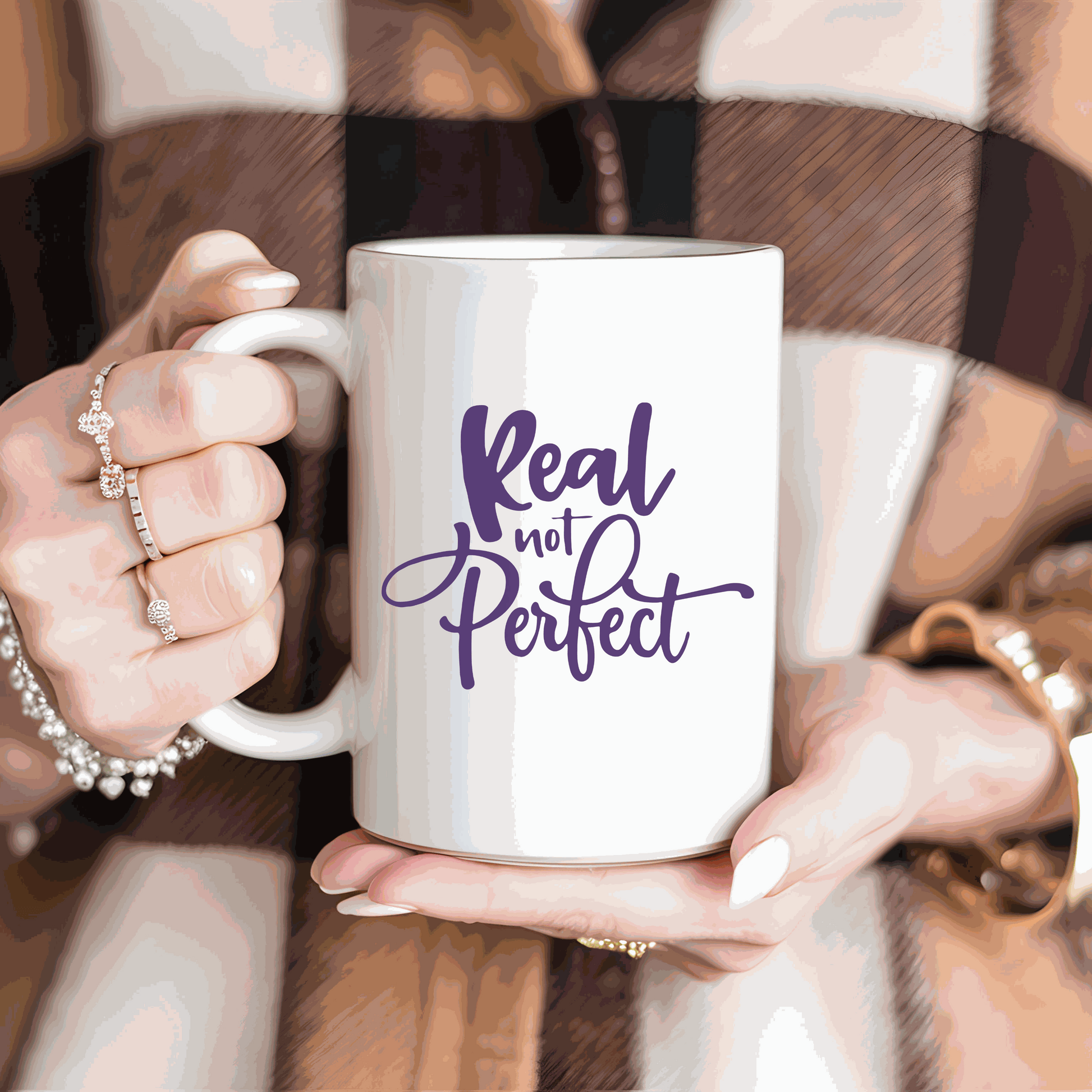 Real Not Perfect ceramic coffee mug with inspirational quote in purple text.