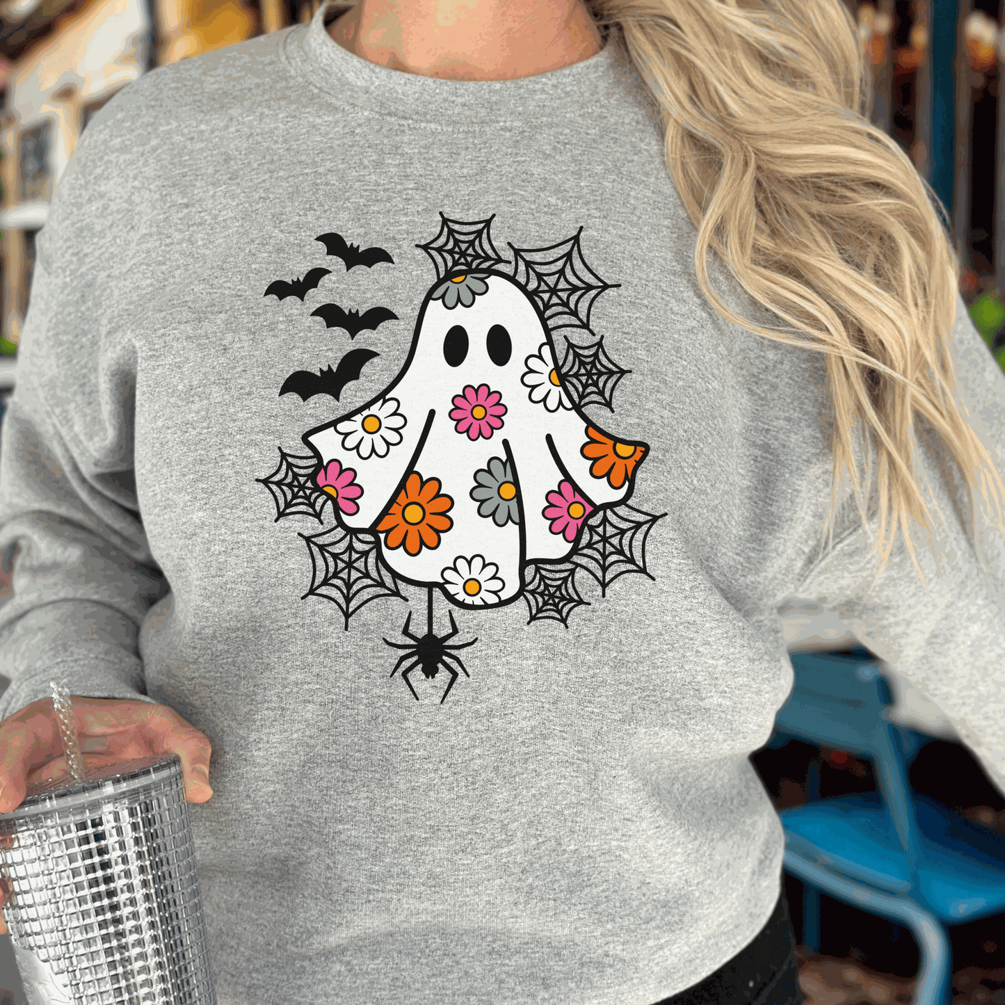 Women's spooky ghost print sweatshirt for Halloween celebrations.