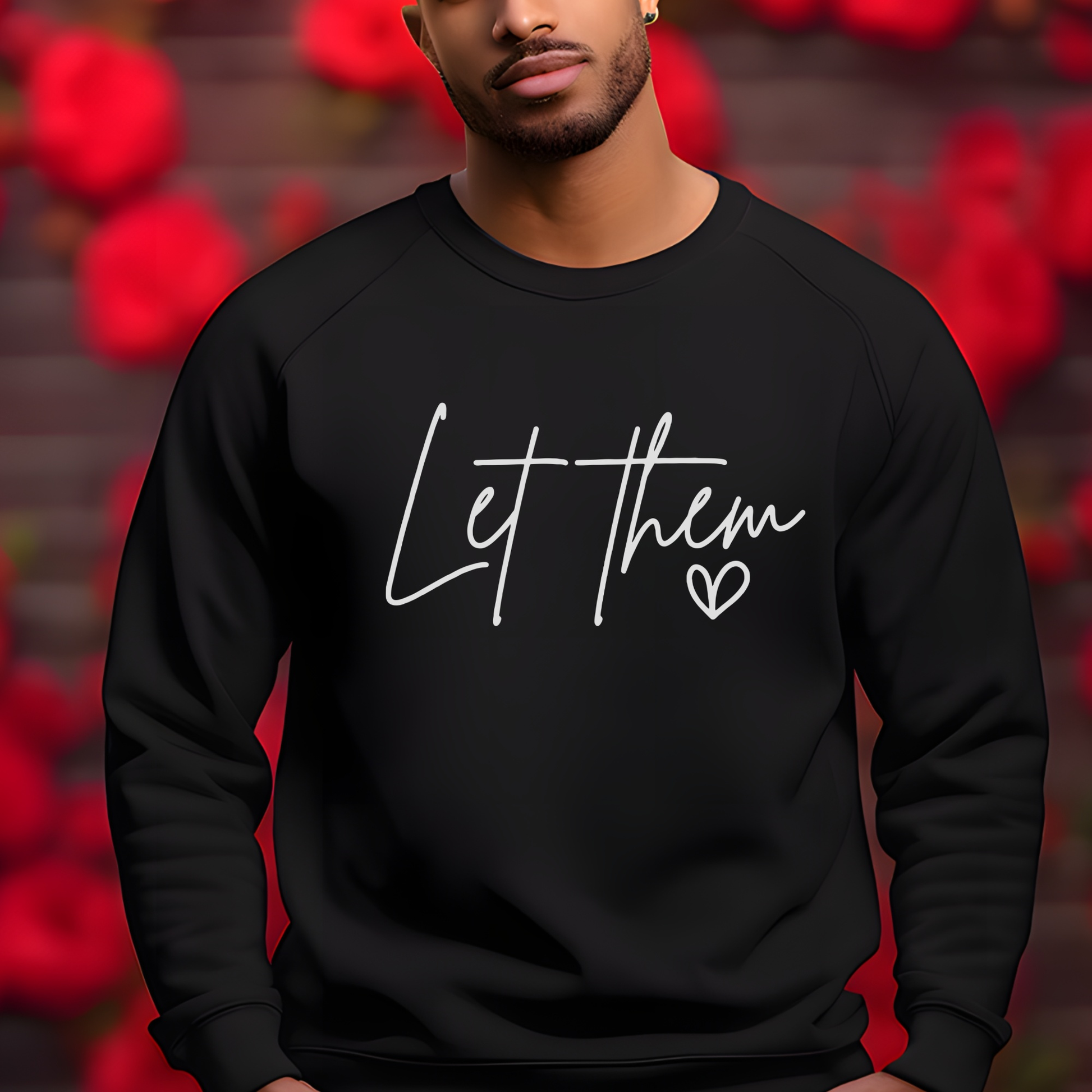 Black crewneck sweatshirt with "Let Them" in handwritten script and heart accent.