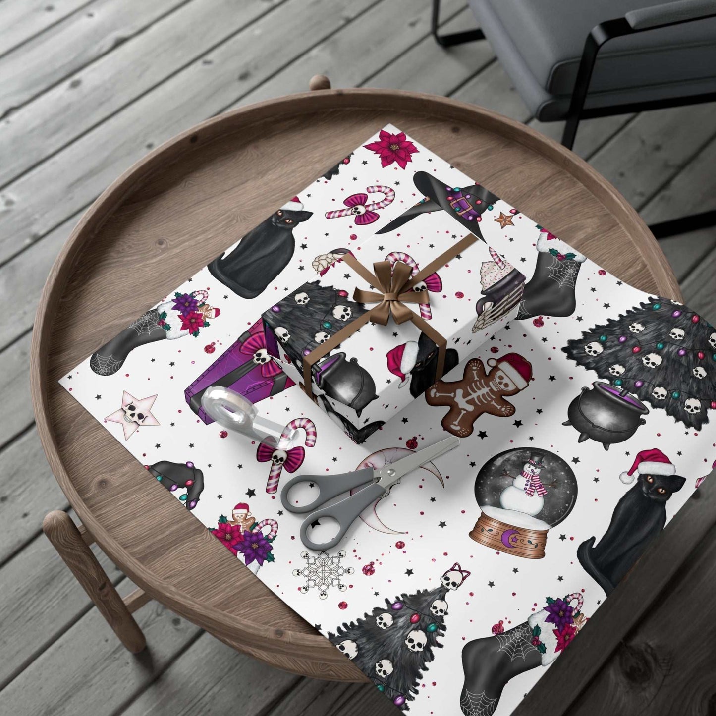 Gothic Christmas wrapping paper with black cat design on a wooden table.