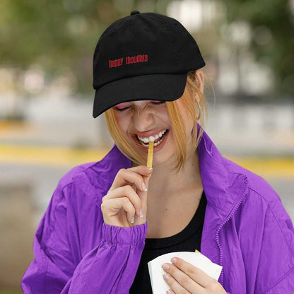 Black personalized cap with red embroidery worn by woman in purple jacket outdoors