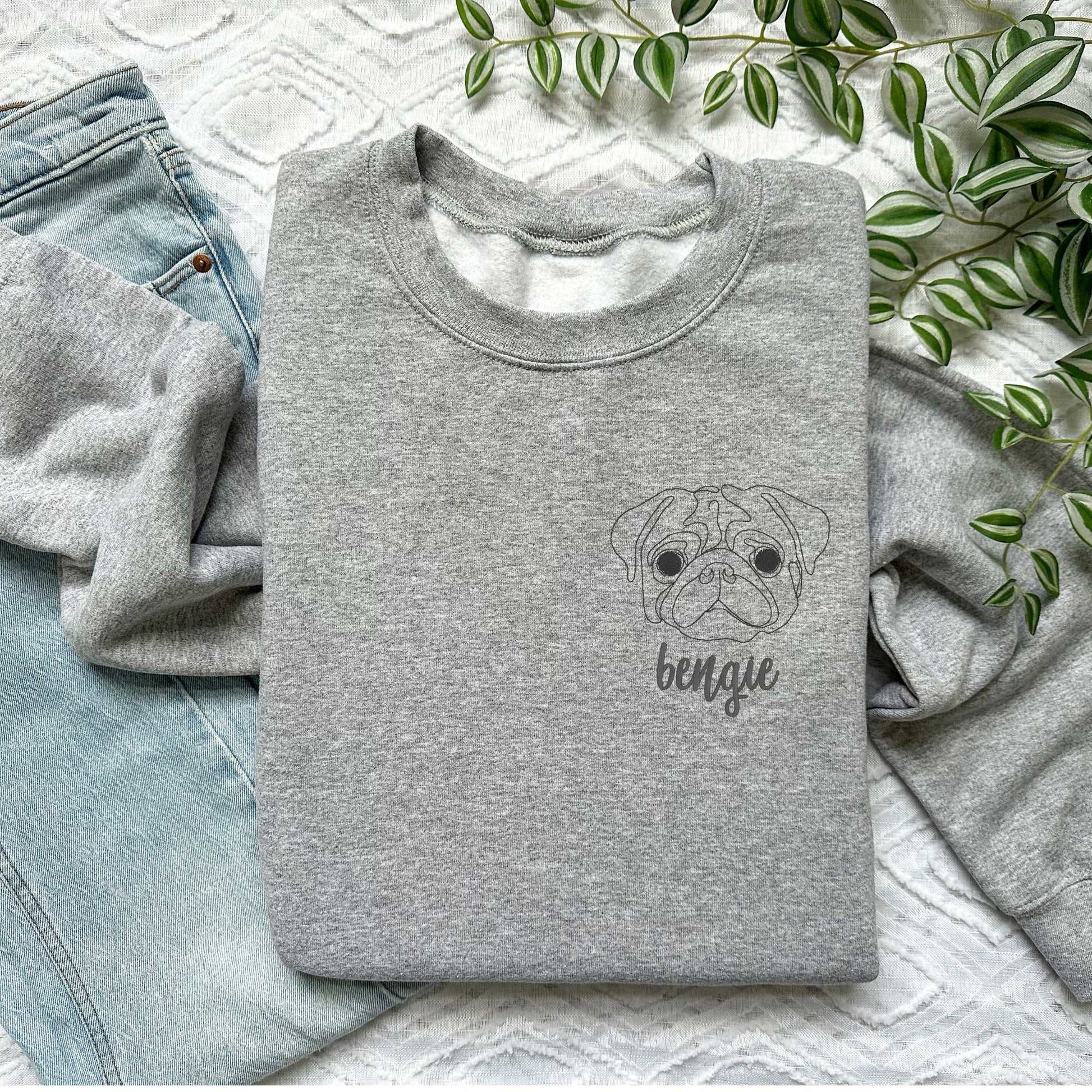 Gray classic crewneck sweater with embroidered pug face and cursive name "bengie" on chest