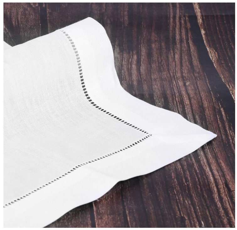 Reusable cloth napkin with nature-themed botanical design, cream white linen blend with hemstitch finish.