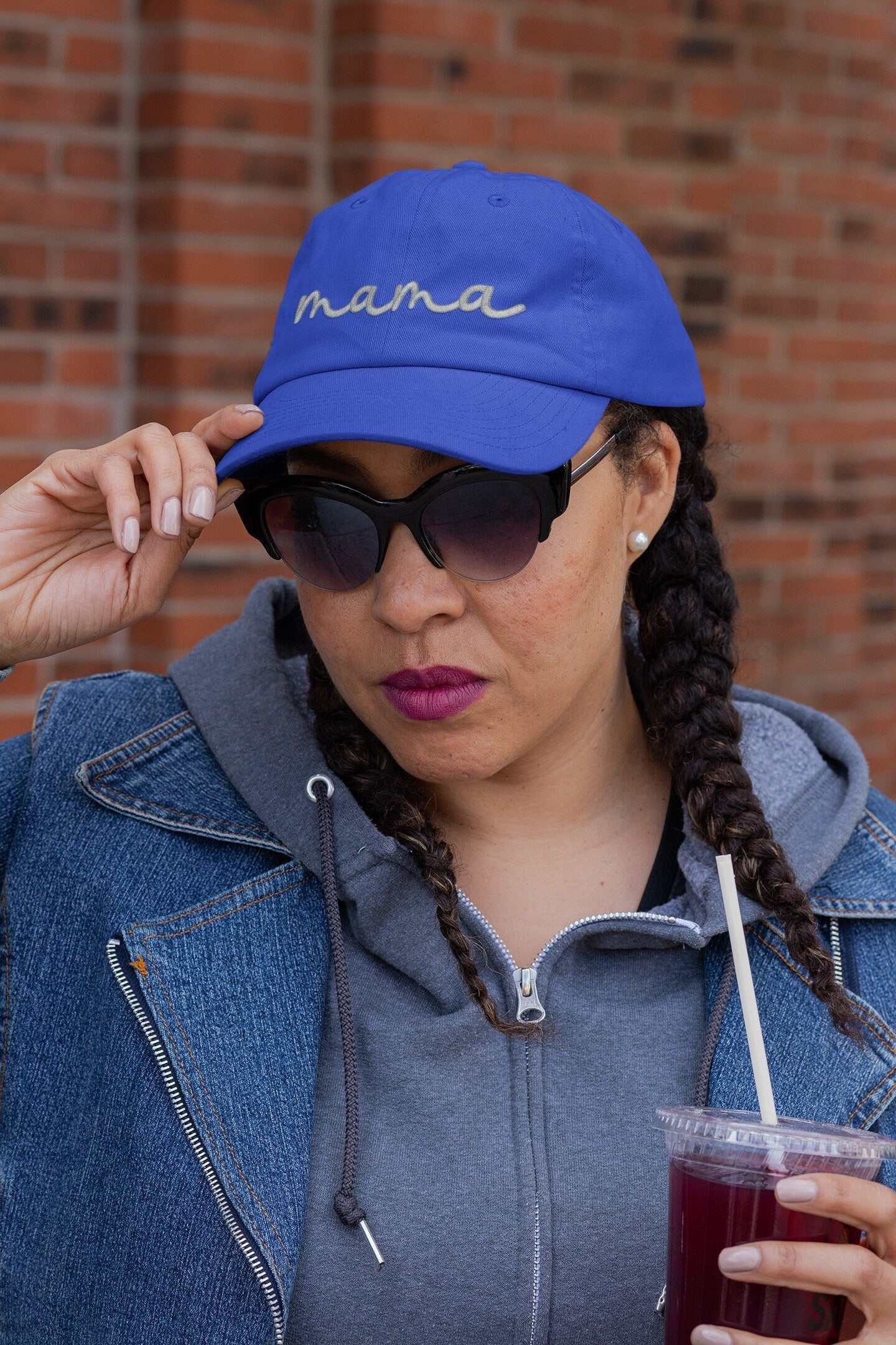 Personalized blue baseball cap with embroidered "mama" design.