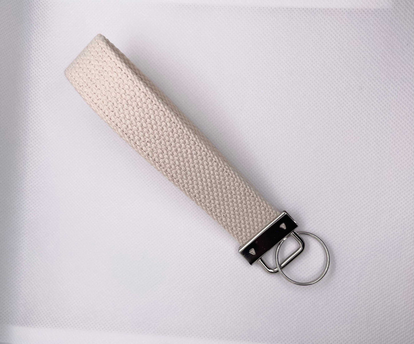 Personalized canvas wristlet keychain with metal hardware.