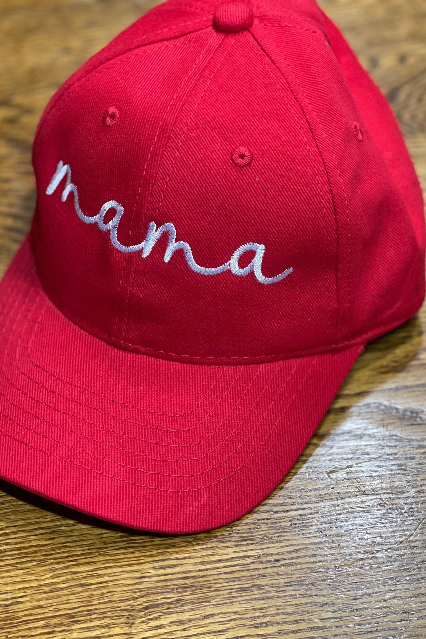 Red embroidered "Mama" baseball cap with personalized stitching on heavyweight brushed cotton.