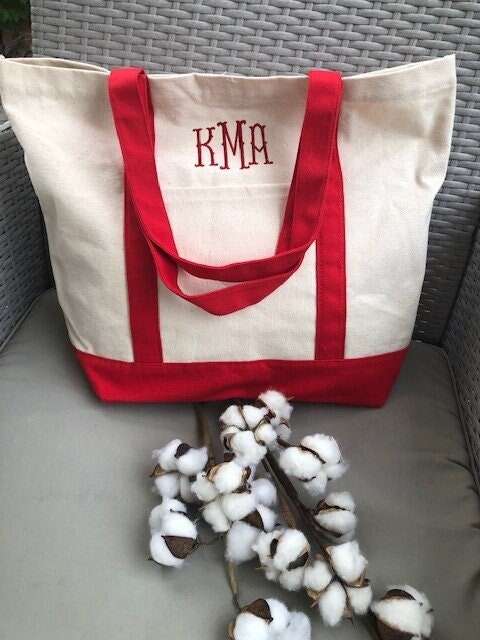 Personalized embroidered tote bag with red straps and monogram initials "KMA".