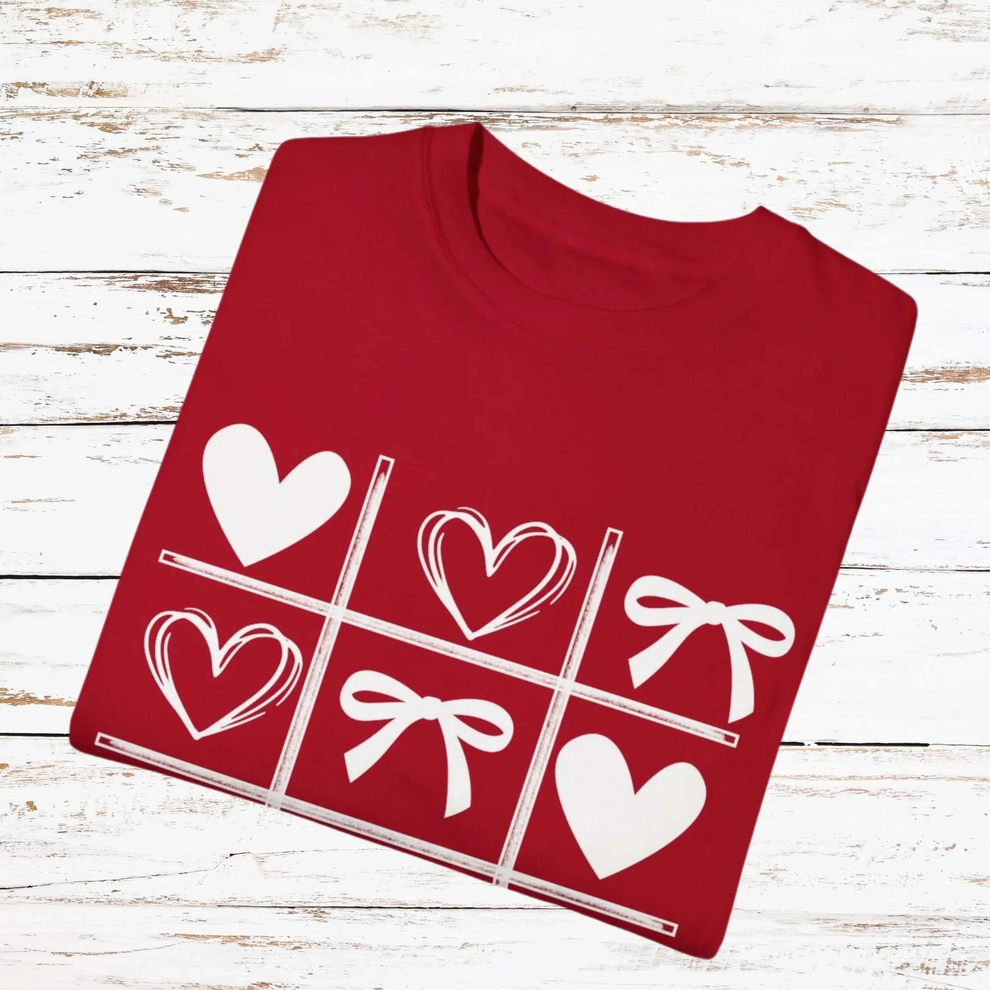 Valentine's Day shirt with hearts and bows in tic-tac-toe pattern.