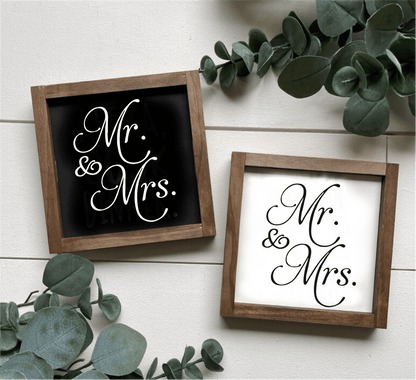 Handcrafted "Mr and Mrs" framed wood signs in black and white backgrounds with leafy decor.