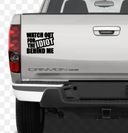 Funny car decal with "Watch out for the Idiot Behind Me" text on a vehicle.