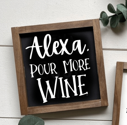 Handcrafted "Alexa, Pour More Wine" wood sign with black background and white lettering.