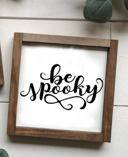 Handmade "Be Spooky" wooden sign with black script on a white background, framed in wood.