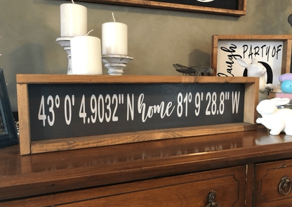 Handmade personalized home coordinates wood sign with natural pine frame, black background, and white lettering, perfect for gifts.