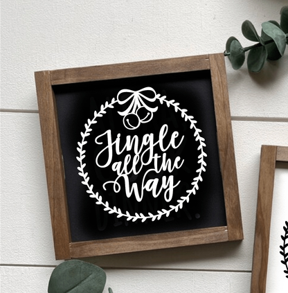 Handcrafted "Jingle All the Way" framed wood sign with black background and white lettering, perfect for festive home decor.