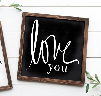 Handcrafted wood sign with "Love You" text, black background, and stained frame. Suitable for home decor.