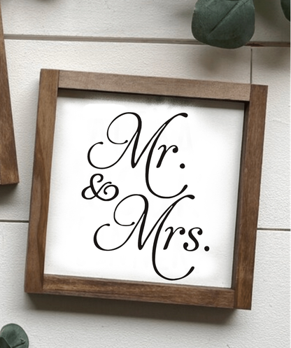 Handcrafted "Mr and Mrs" wood sign with stained frame and black lettering on a white background.