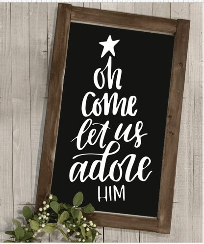 Framed handmade Christmas sign with "Oh Come Let Us Adore Him" text in white on a black background.