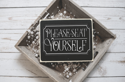 Handcrafted wood sign with "Please Seat Yourself" text in a rustic frame.