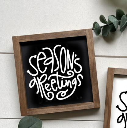 Season's Greetings holiday wood sign with handcrafted design, black background, and white lettering.