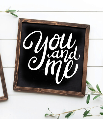 Handmade "You and Me" inspirational wood sign with black background and white lettering.